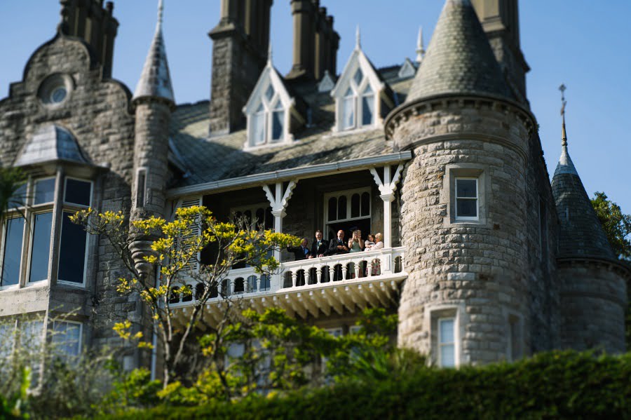 wedding guests on the balcony at Chateau Rhianfa