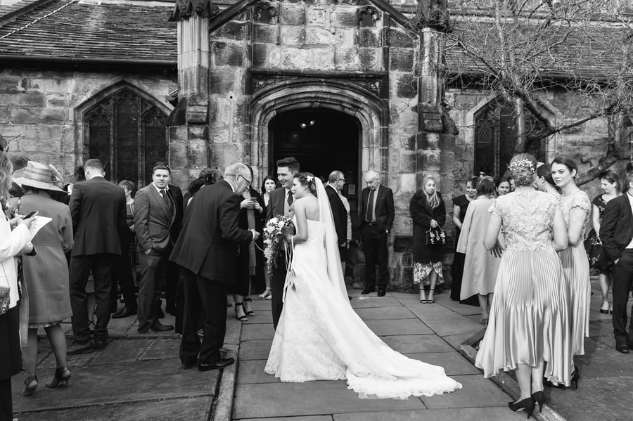 guests mingling outside cheshire church wedding 3