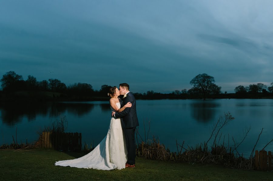bride and groom at sandhole oak barn wedding night by the lake