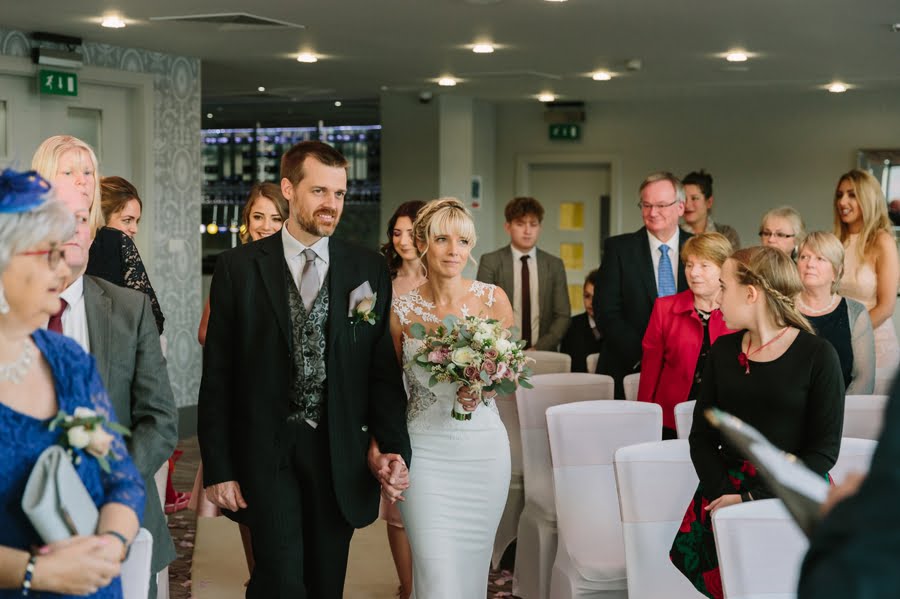 bride and brother walking down the aisle at Quay hotel and spa wedding