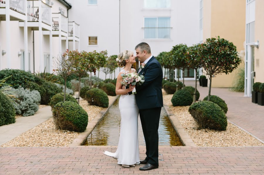 bride and groom in courtyard at Quay hotel and spa wedding