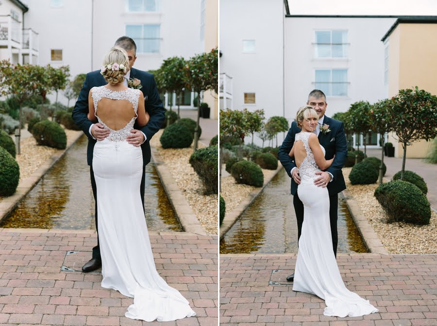 bride and groom in courtyard at Quay hotel and spa wedding again