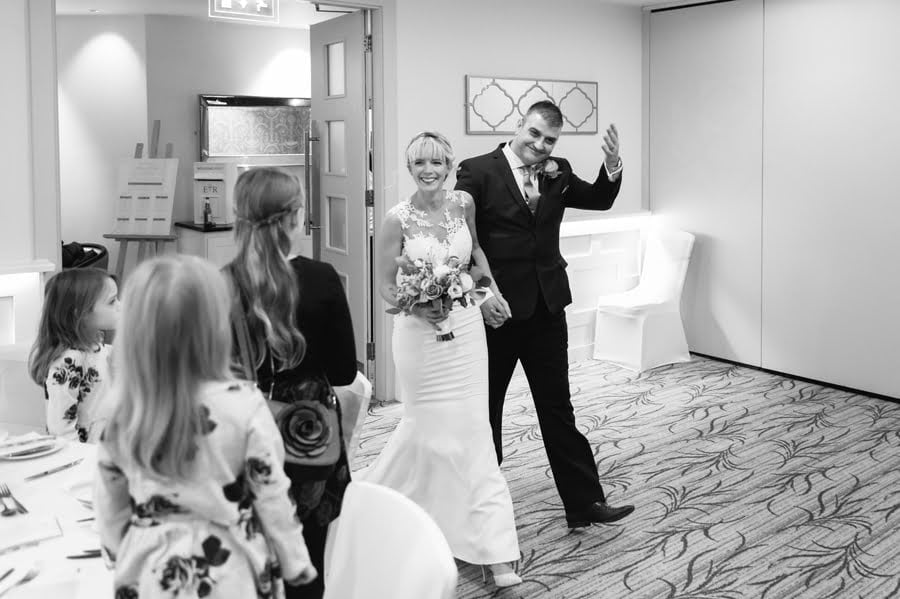 bride and groom arrive at Quay hotel and spa wedding