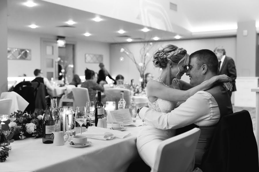 bride and groom cuddling at Quay hotel and spa wedding breakfast