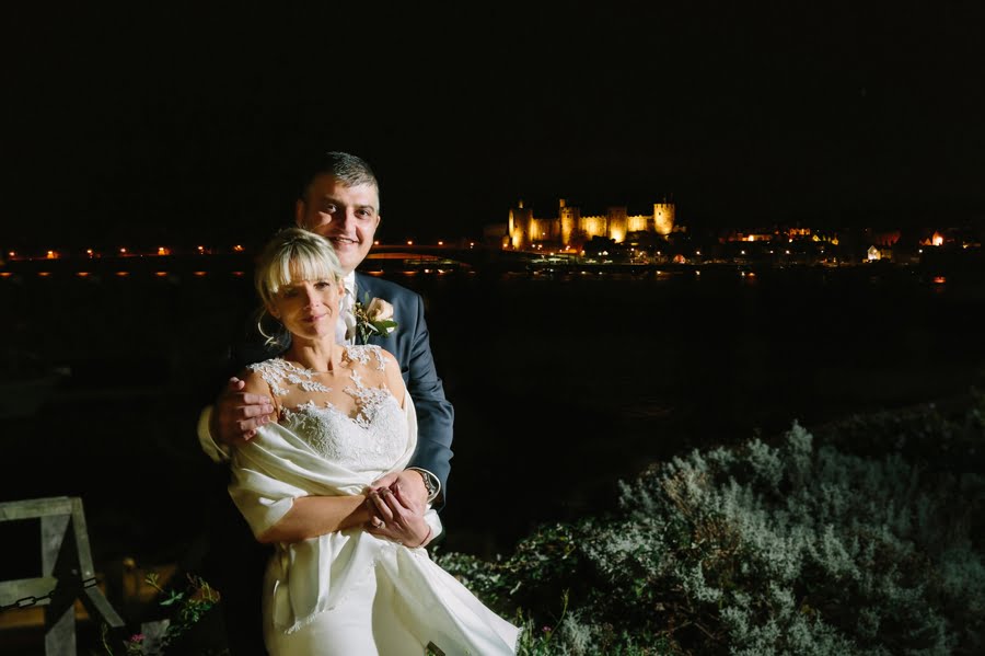 bride and groom at night with Conwy castle at Quay hotel and spa wedding