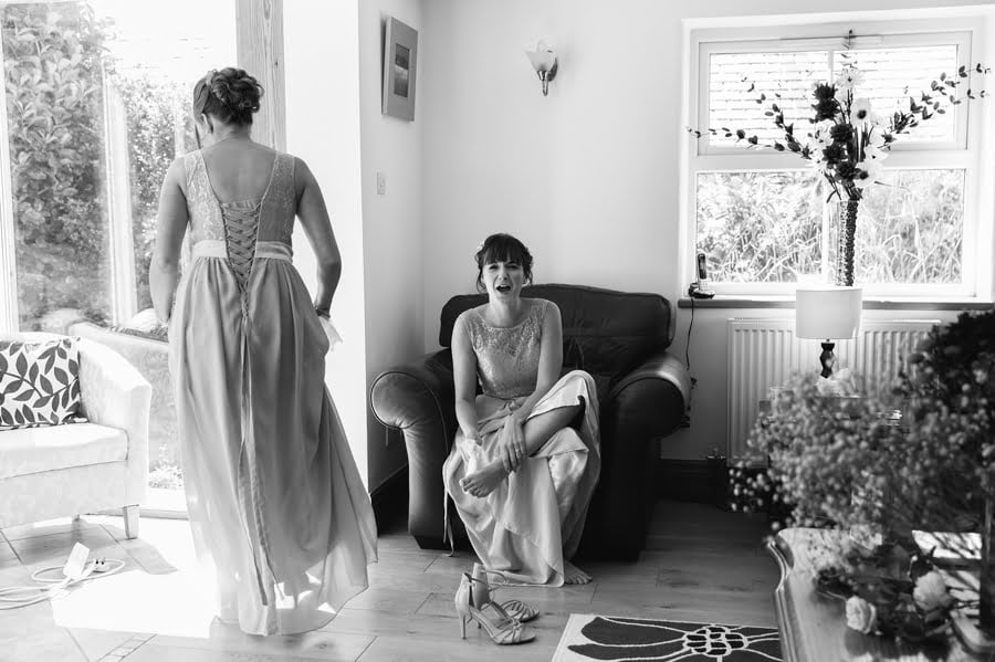 bridesmaid wiping feet at Bryn Eisteddfod wedding