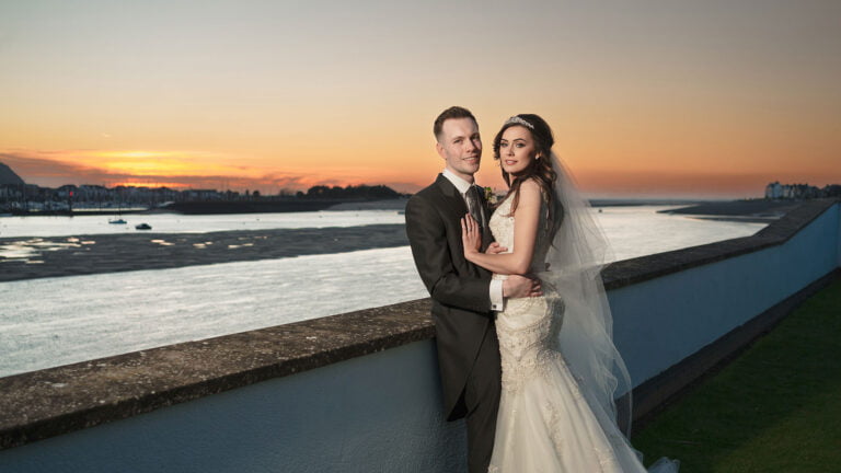 bride and groom with sunset at Quay hotel deganwy